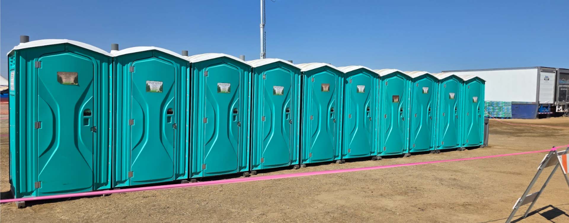 row of porta potties in job site in visalia, ca
