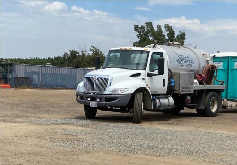 pumping truck with porta potties on the back, ready for commercial septic pumping in visalica, ca