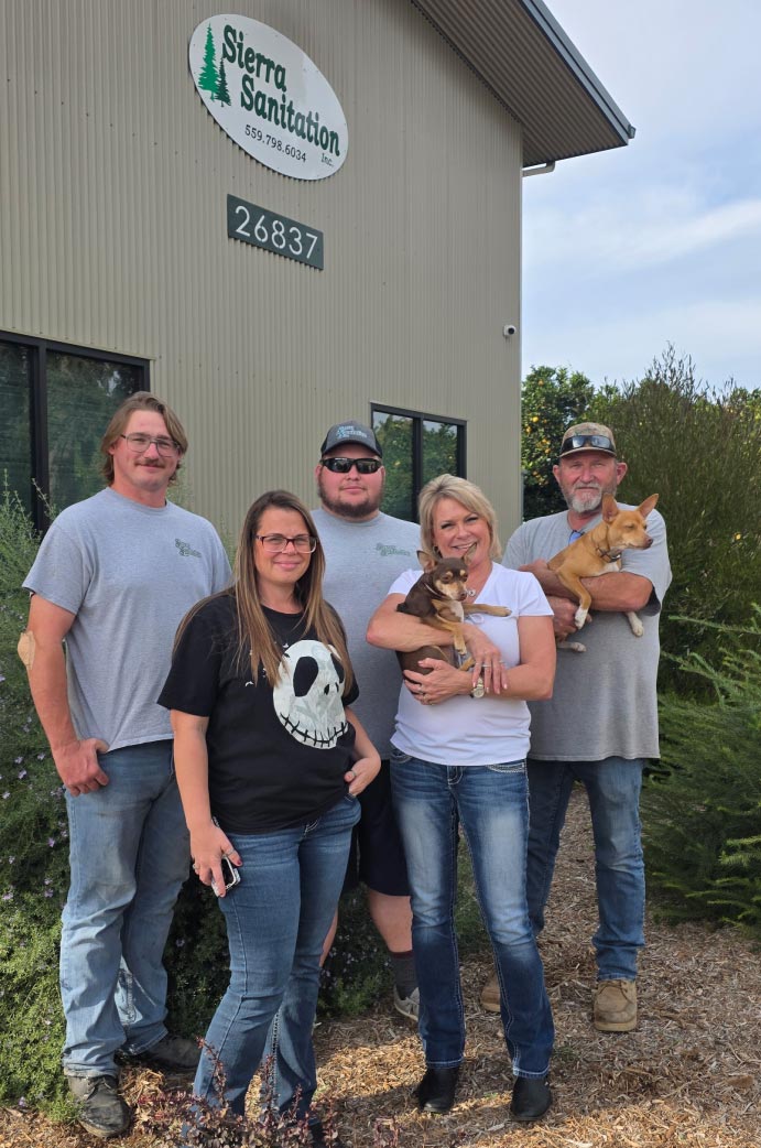 picture of the sierra sanitation team and family with two chihuahuas 